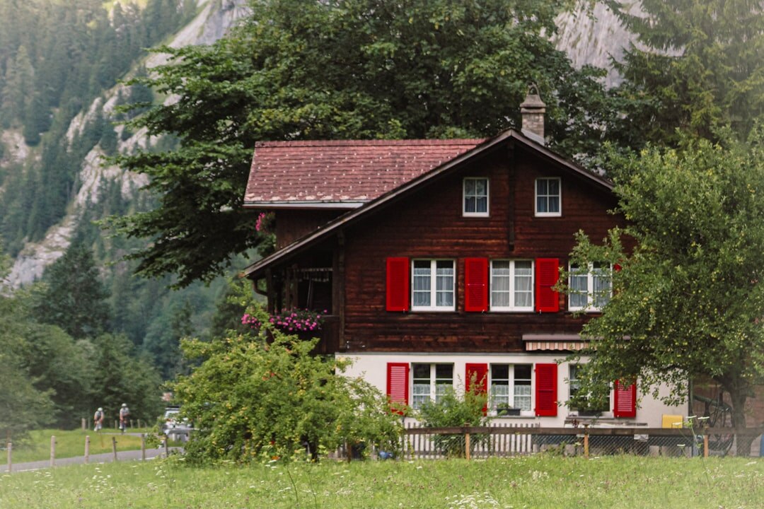 Traditional Swiss wooden chalet with balconies in the alps