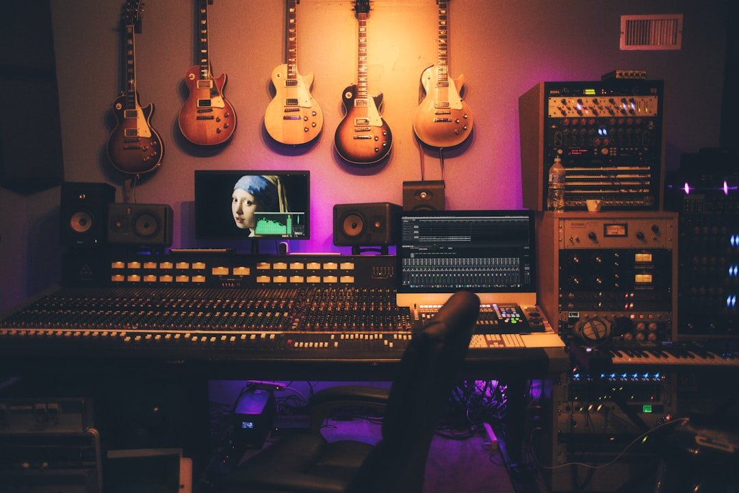 Home music recording studio with mixing desk and instruments